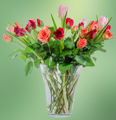 Red Roses flowers with pink tulips, transparent vase.