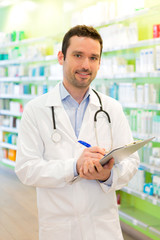 Fototapeta premium Attractive pharmacist taking notes at work