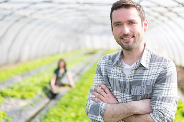 Portrait of an attractive farmer in a greenhouse