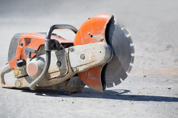Concrete gasoline saw grinder at construction site 