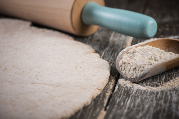 rolling wholegrain dough for homemade bread - obrazy, fototapety, plakaty
