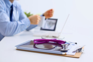 Male doctor sitting at his desk