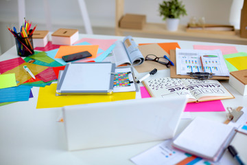 Designer&#39;s table with notes and tools