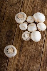 Fresh champignons on wooden board