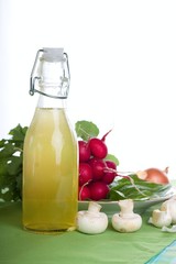 Home orange lemonade on table with champignons and radishes