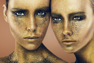 women faces in gold glitters