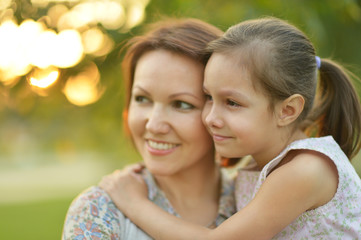 Fototapeta na wymiar Little girl with mother in park