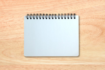 white page of notebook on wood texture