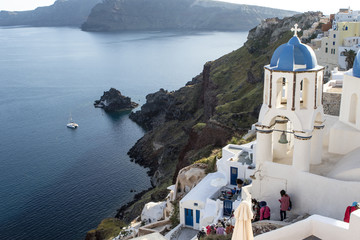 Obraz premium Clock tower with a blue roof of a Greek Orthodox church in Oia, Santorini (Thira) , Cyclades in Greece