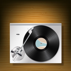 vinyl record turntable on woooden background