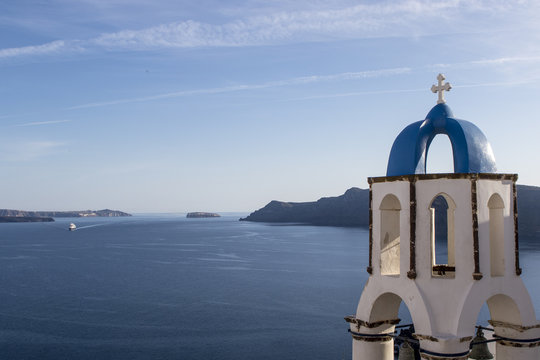 Clock tower with a blue roof of a Greek Orthodox church in Oia, Santorini (Thira) , Cyclades in Greece