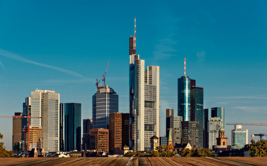 Fototapeta na wymiar background with wooden deck table and Skyline in Frankfurt