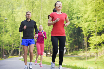 Obraz premium Smiling friends running outdoors.
