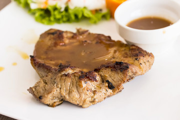 Close up of pork steak on a white plate