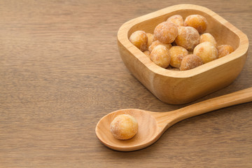 macadamia nuts in a wooden spoon