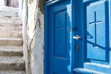 Blue door with a cross of a Greek Orthodox chapel in Oia, Santorini, Cyclades, Greece, Europe 