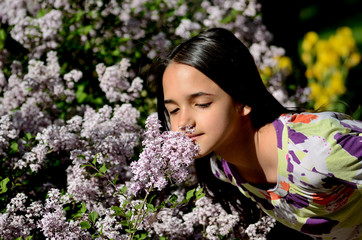 Little Hispanic Girl Stop to Smell the Flowers on a Spring Day