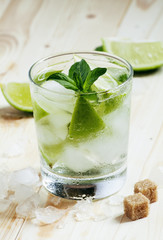 Fresh cocktail witn soda, lemon and mint, selective focus