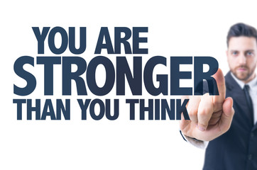 Business man pointing the text: You Are Stronger Than You Think
