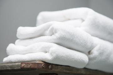 white towel placed on shelves in bathroom of hotel