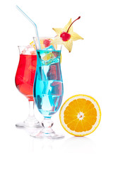 Two tropical cocktails and orange