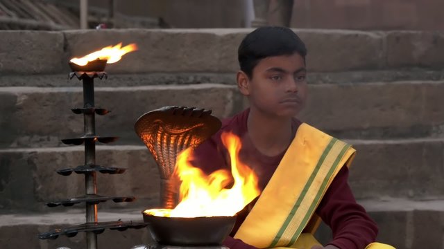 varanasi, india, young monk and sacred fire