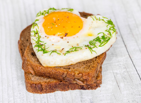 Sandwich with fried eggs in the shape of a heart