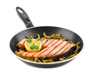 Frying pan with salmon steak.