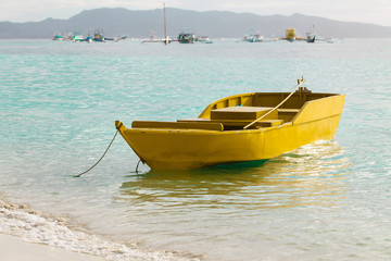 Obraz premium Small yellow boat on blue tropical sea, Philippines Boracay isla