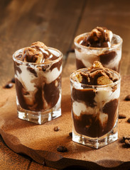 Dessert of ice cream and chocolate, decorated with cocoa and cof