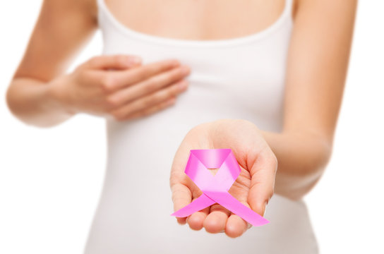 Woman holding a pink cancer awareness ribbon