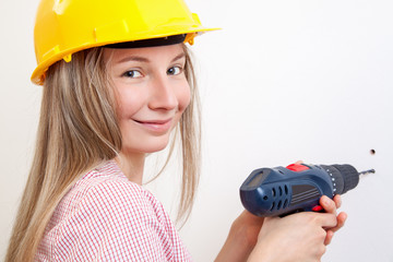 Woman doing the DIY work and wearing protective helmet