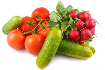 Tomatoes, cucumbers and radishes on a white background