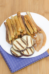 Fries potatoes with grilled eggplant on wooden background