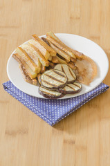 Fries potatoes with grilled eggplant on wooden background
