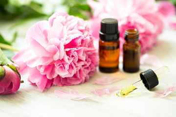 Obraz na płótnie Canvas Aromatherapy, essentials oils, peony flowers