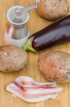 Backon with vegetables and salt on wooden background