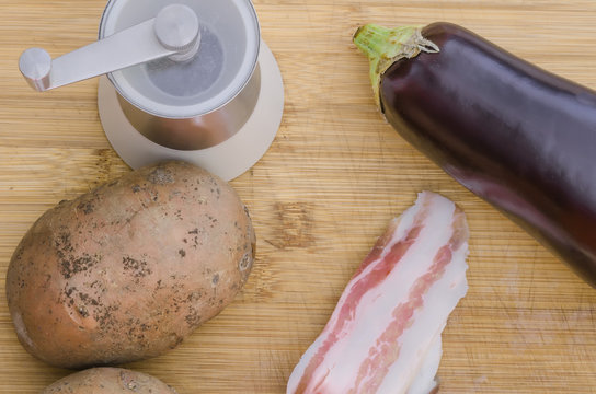 Backon with vegetables and salt on wooden background