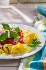 Delicious pappardelle pasta with tomato sauce and parmesan