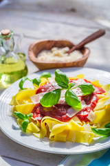 Tasty pappardelle pasta in the sunny kitchen