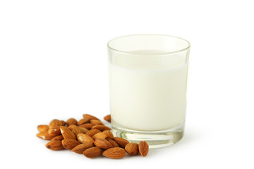 Glass of milk with almonds isolated on white