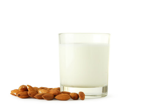 Glass of milk with almonds isolated on white