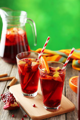 Glasses of sangria on grey wooden background