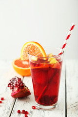 Glass of sangria on white wooden background
