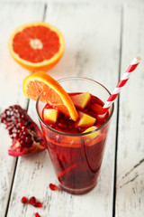 Glass of sangria on white wooden background
