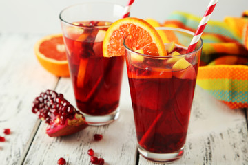 Glasses of sangria on white wooden background