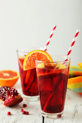 Glasses of sangria on white wooden background