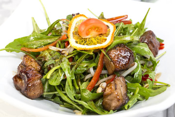 duck with arugula on a white background in the restaurant