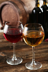 Red and white wine glass with bottle and barrel