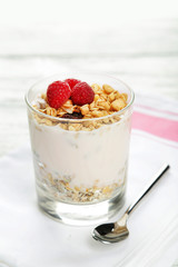 Muesli with yogurt and raspberries in a glass 
